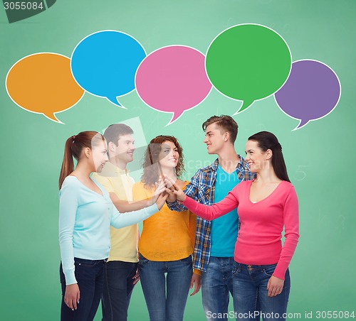 Image of smiling teenagers making high five