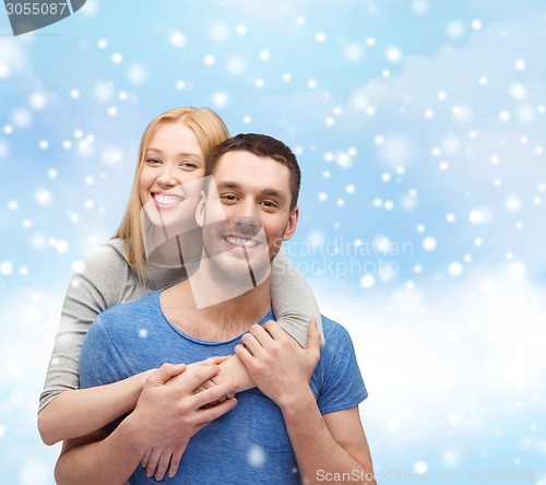 Image of happy couple hugging outdoors