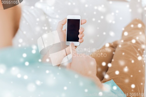 Image of close up of man with smartphone at home
