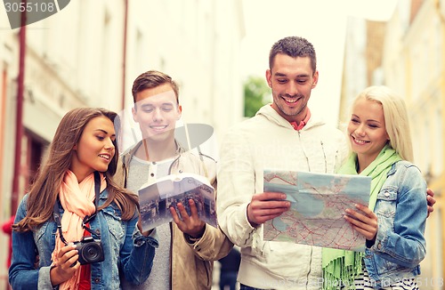 Image of group of friends with city guide, map and camera