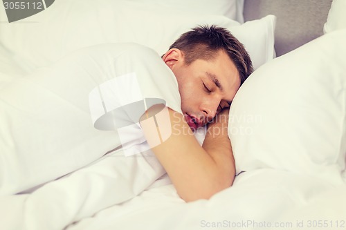 Image of handsome man sleeping in bed