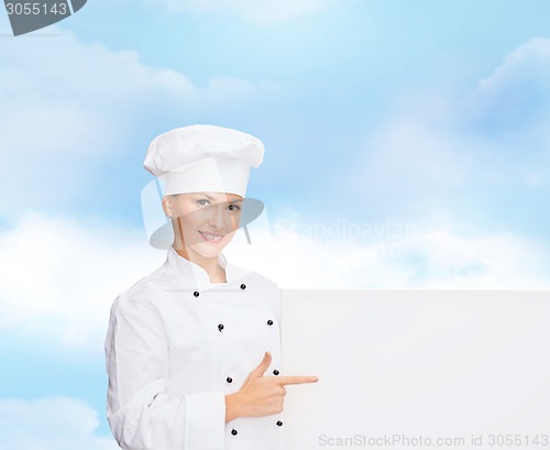 Image of smiling female chef with white blank board