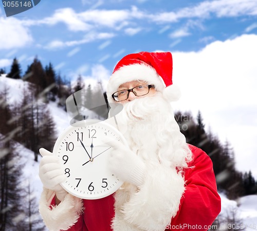 Image of man in costume of santa claus with clock