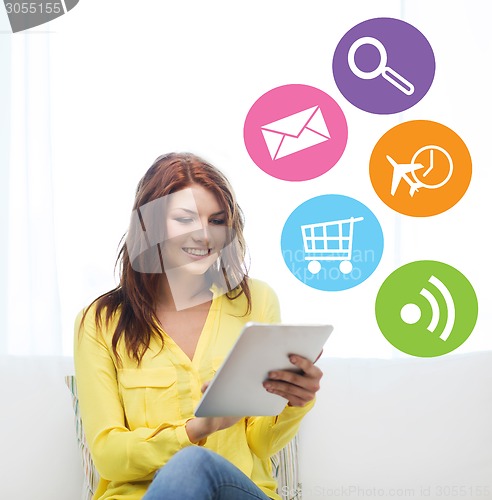 Image of smiling woman with tablet pc computer at home