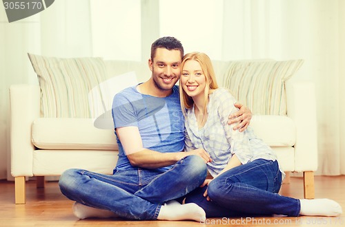 Image of smiling happy couple at home