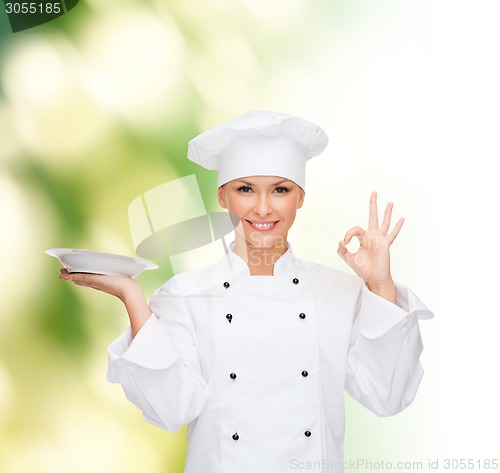 Image of female chef with plate showing ok sign