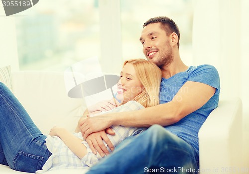 Image of smiling happy couple at home