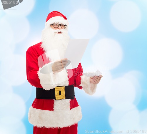 Image of man in costume of santa claus with letter