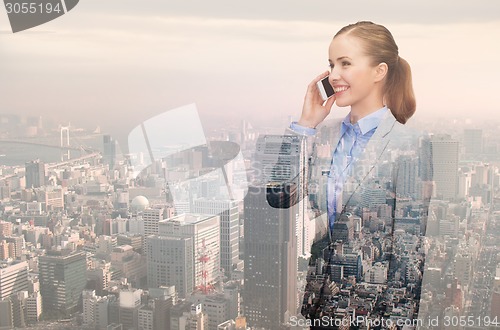 Image of smiling young businesswoman over city background