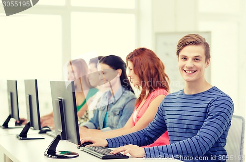 Image of male student with classmates in computer class