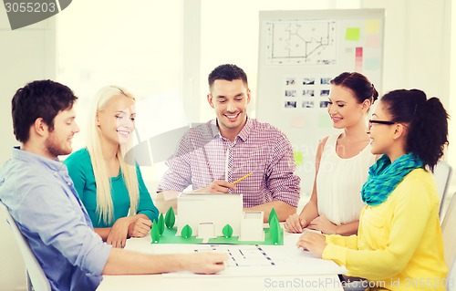 Image of smiling architects working in office