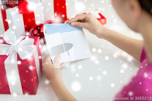 Image of close up of woman with letter and presents