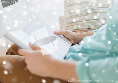 Image of close up of man reading book at home