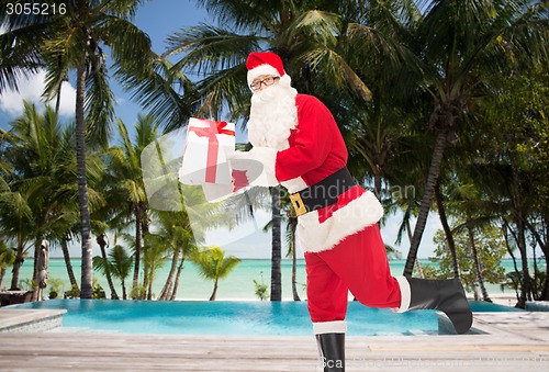 Image of man in costume of santa claus with gift box