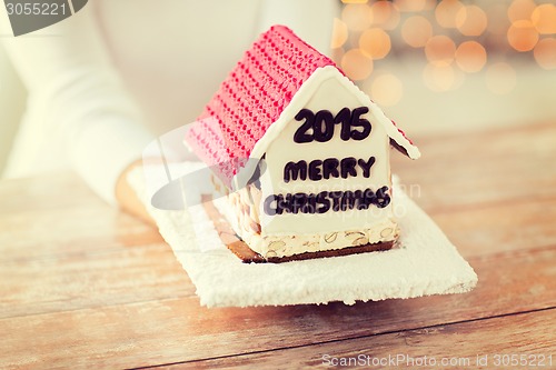 Image of close up of woman showing gingerbread house