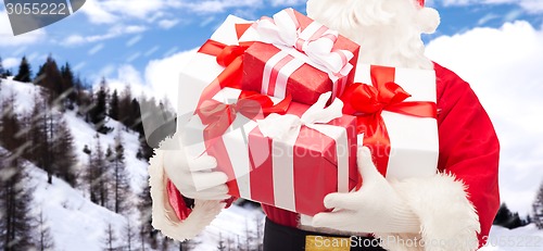 Image of man in costume of santa claus with gift box