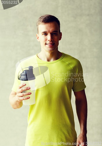 Image of smiling man with protein shake bottle