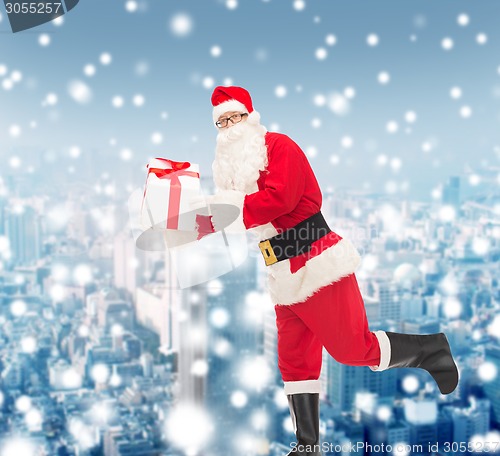 Image of man in costume of santa claus with gift box