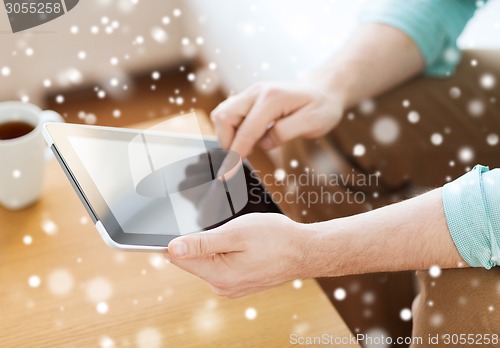 Image of close up of man with laptop and cup at home