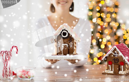 Image of close up of woman showing gingerbread house