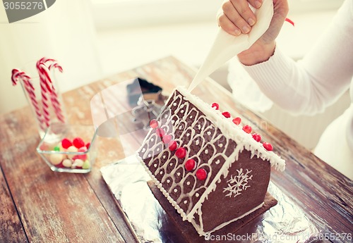 Image of close up of woman making gingerbread houses