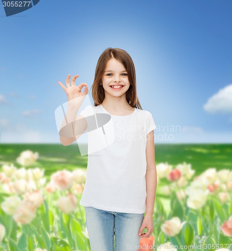 Image of smiling little girl in white blank t-shirt