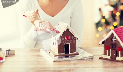 Image of close up of woman making gingerbread houses