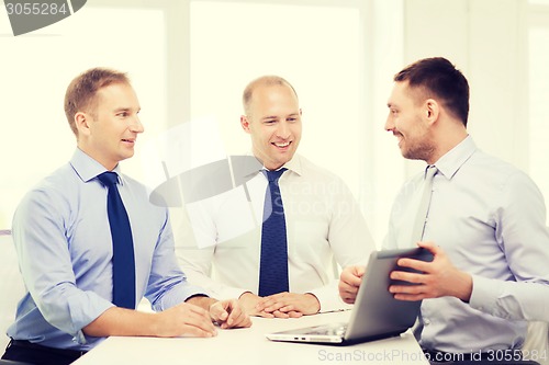 Image of business team working with laptop in office
