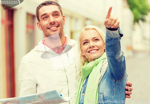 Image of happy couple with map exploring city