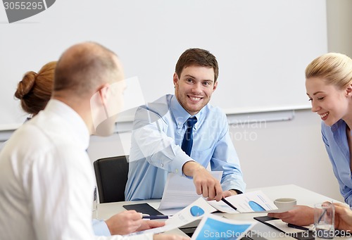 Image of business people with papers meeting in office