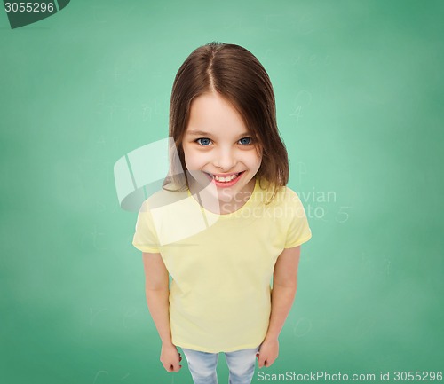 Image of smiling little girl over green grass background