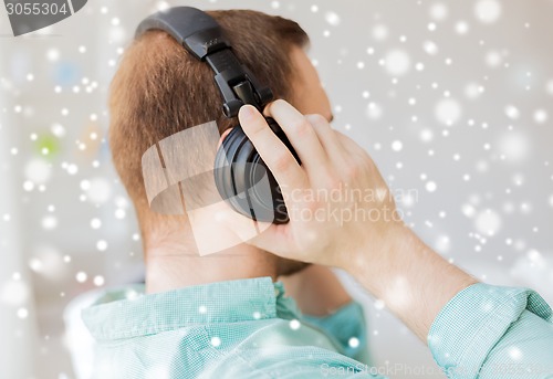 Image of close up of man in headphones at home