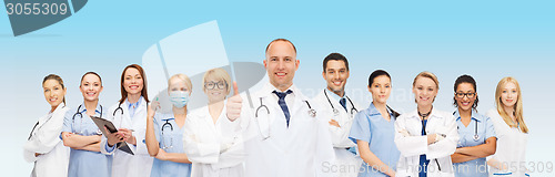 Image of group of smiling doctors with showing thumbs up