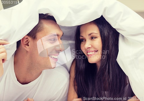 Image of happy couple sleeping in bed