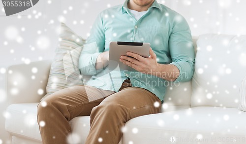 Image of close up of man with tablet pc computer at home