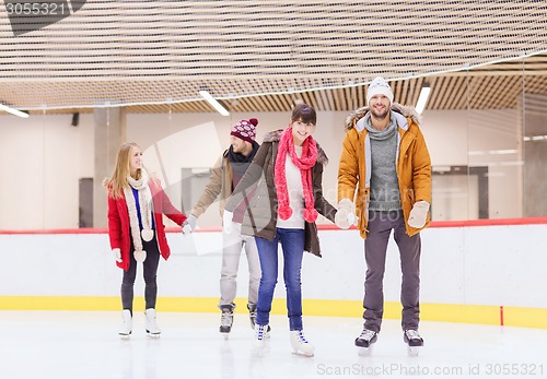 Image of happy friends on skating rink