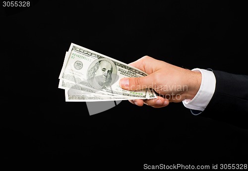 Image of close up of male hand holding dollar cash money