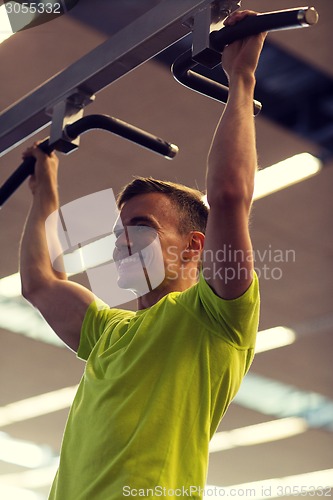 Image of smiling man exercising in gym