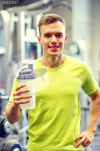 Image of smiling man with protein shake bottle