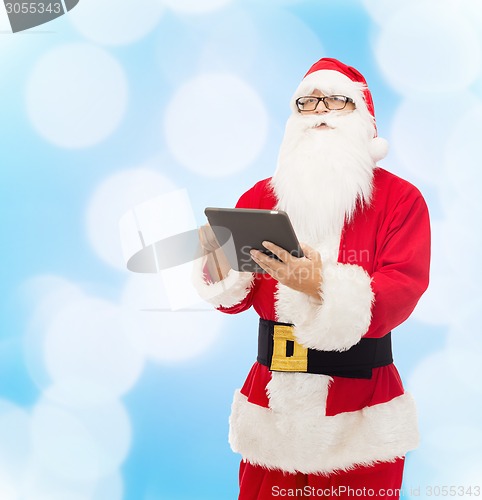 Image of man in costume of santa claus with tablet pc