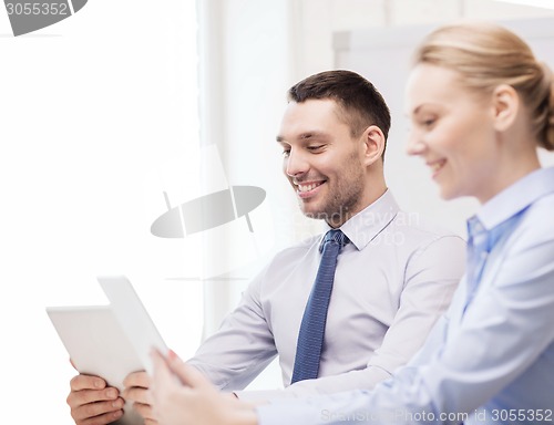 Image of business team working with tablet pc in office