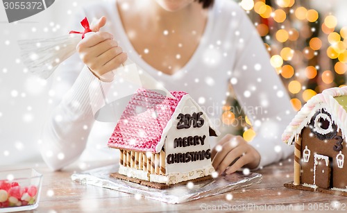 Image of close up of woman making gingerbread houses