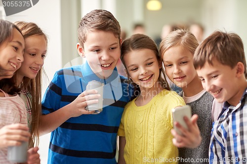 Image of group of school kids with smartphone and soda cans