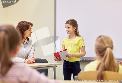 Image of group of school kids with teacher in classroom