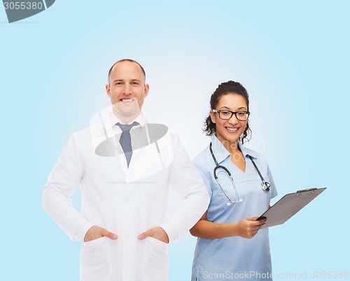 Image of smiling doctors with clipboard and stethoscopes