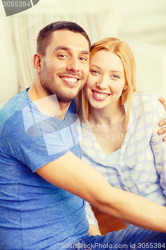 Image of smiling happy couple at home