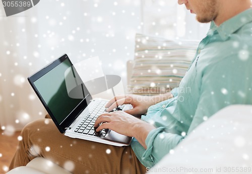 Image of close up of man working with laptop at home