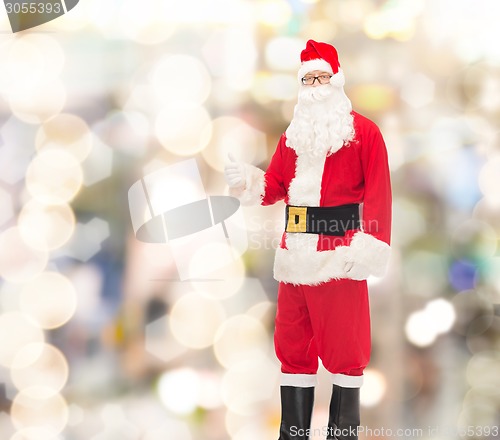Image of man in costume of santa claus showing thumbs up