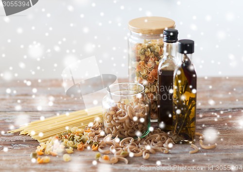 Image of close up of olive oil bottles and pasta in jars