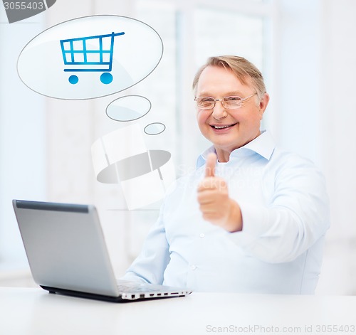 Image of old man with laptop computer showing thumbs up